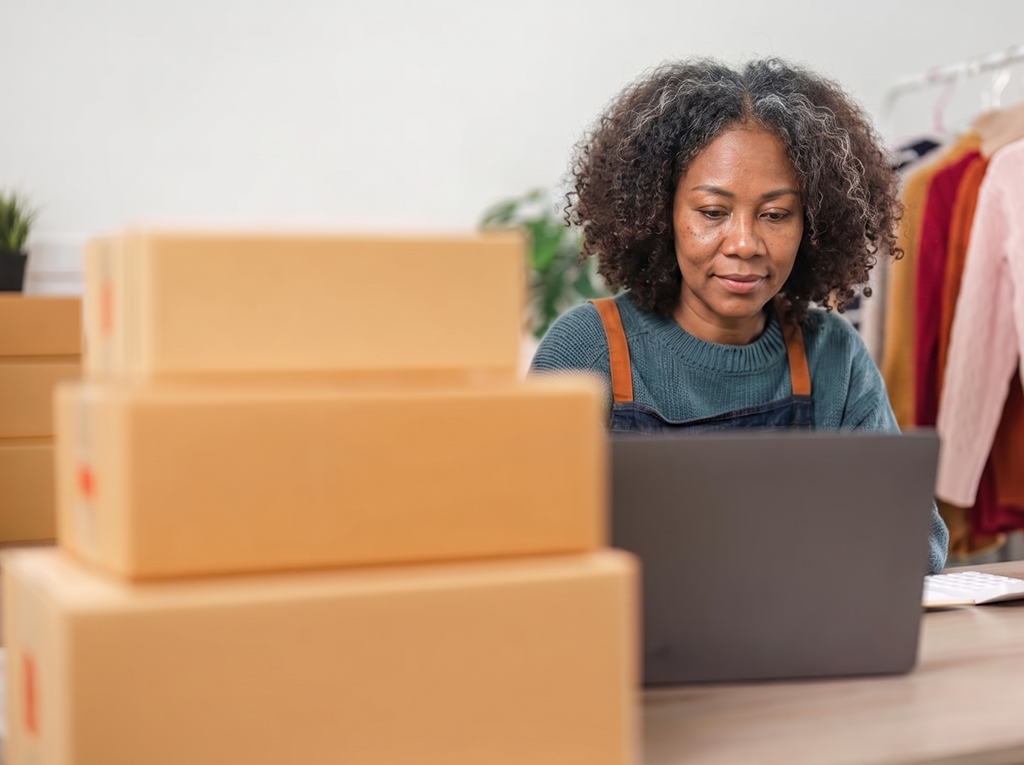 A view of a woman calculating the shipping costs for a package